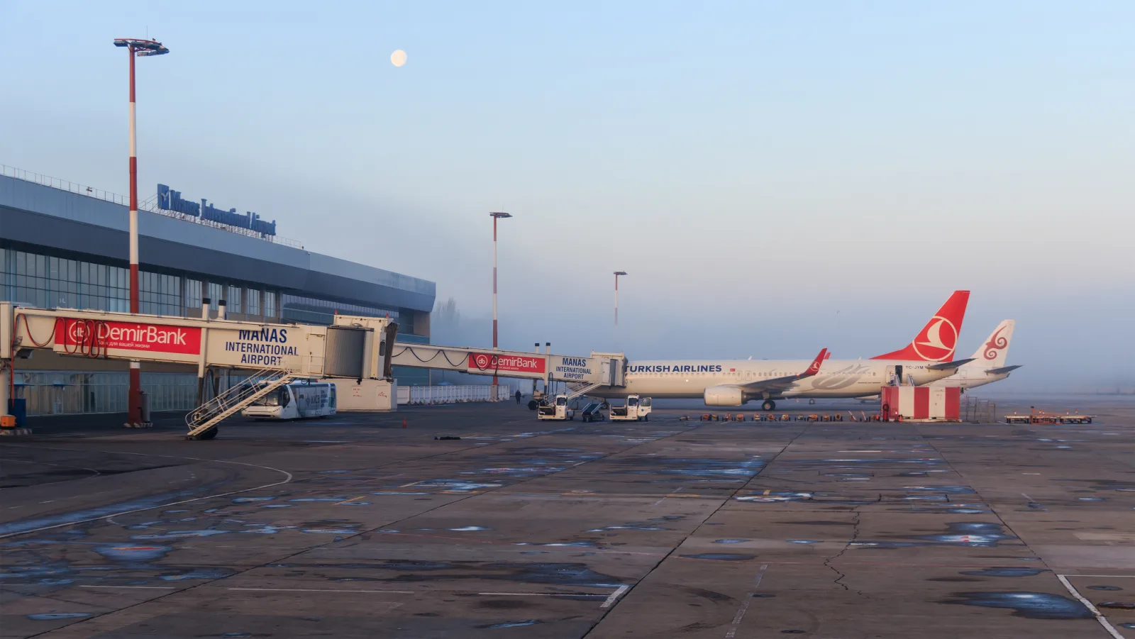 Терминал аэропорта Манас, телетрапы и самолёты на перроне ранним утром